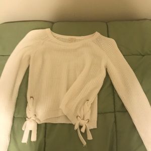 white forever 21 sweater with side detailing.